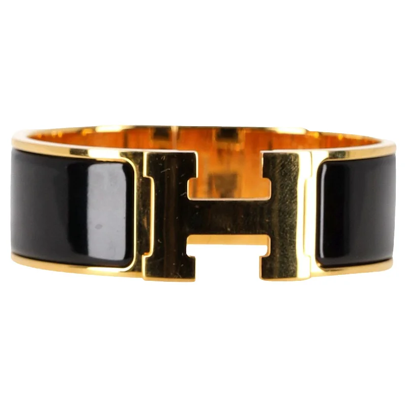 Trending Jewelry Styles Now At Limited-Time Discounts Hermès Clic Clac Bracelet in Black and Gold Metal Trending Jewelry Styles Now At Limited-Time Discounts Hermès Clic Clac Bracelet in Black and Gold Metal